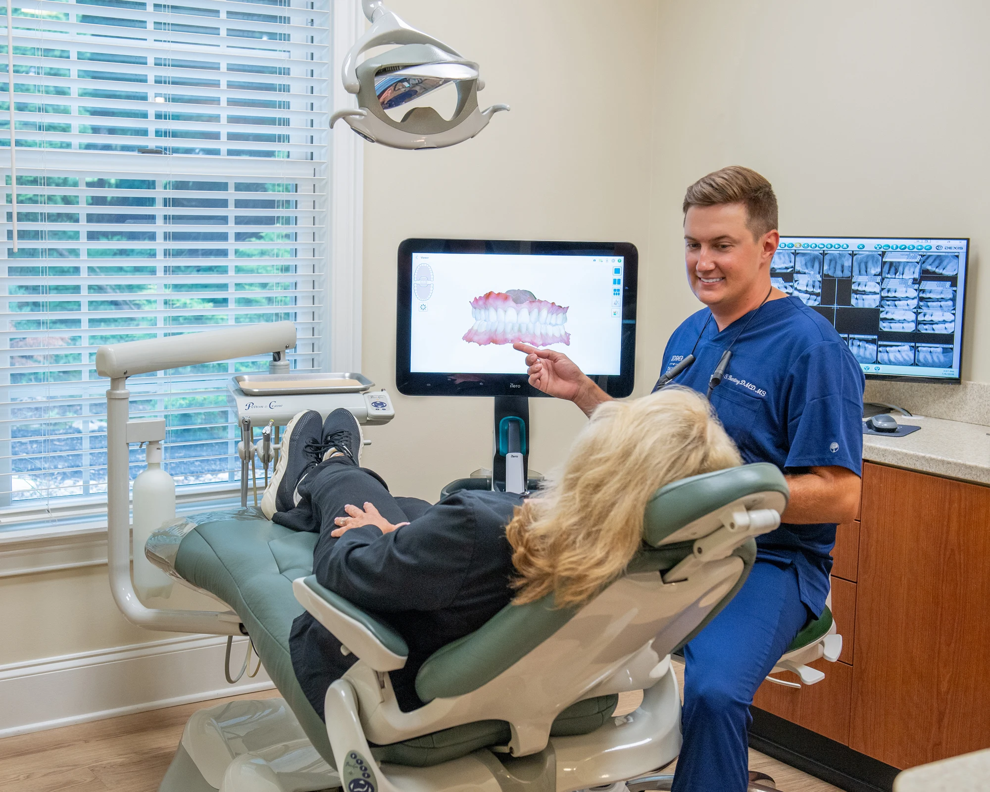 Dr. Eric Bunting discussing a dental scan with a patient